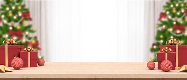 Empty wood table decorated with a gift boxes and christmas ornaments.