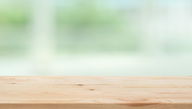 Empty wood table top on blur abstract green garden