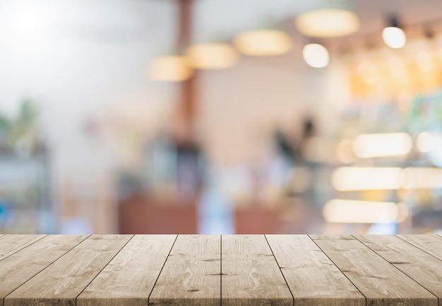 Empty wood table top and blur glass window interior restaurant and cafe