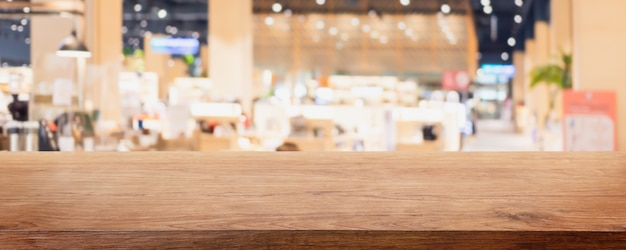 Empty wood table top and blur glass window interior restaurant and cafe