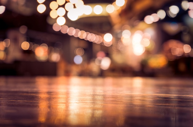 Empty wood table top on blur light gold bokeh of cafe restaurant in dark background/selective focus .For montage product display