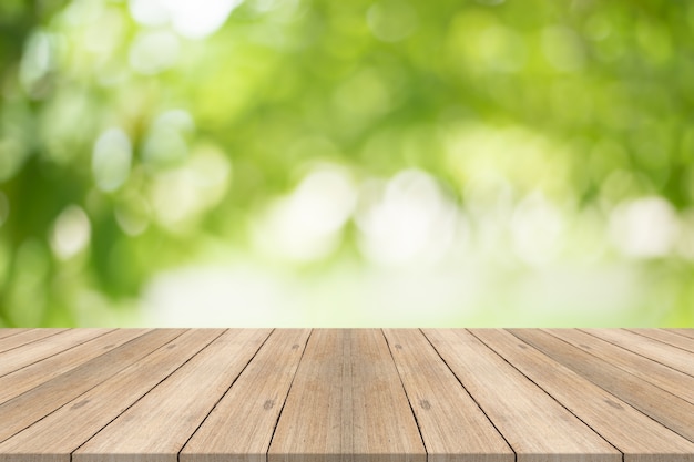 Empty wood table top on blurred abstract green background