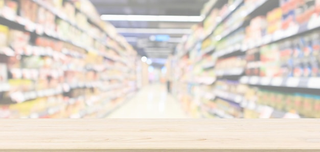 Empty wood table top with abstract supermarket aisle interior blurred defocused background