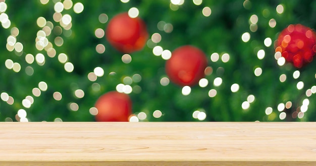 Empty wood table top with blur christmas tree