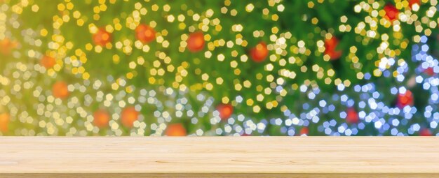 Empty wood table top with blur Christmas tree