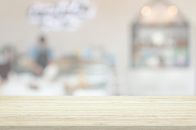 Empty wood table top with cafe restaurant interior blur background