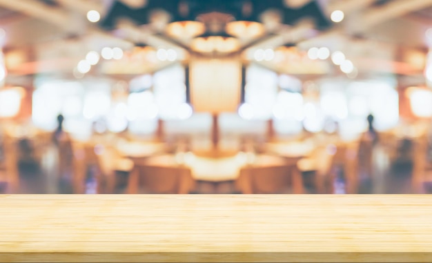 Empty wood table top with cafe restaurant interior blurred background