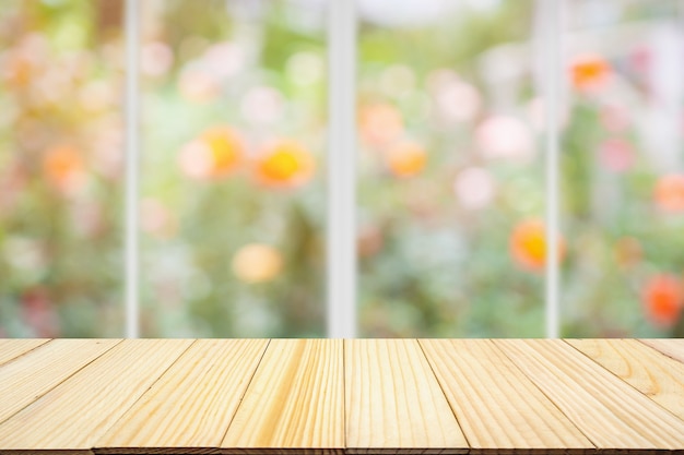 Empty wood table top with kitchen window blur background