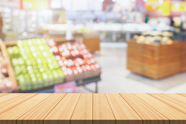 Photo empty wood table top with supermarket blurred background for product display