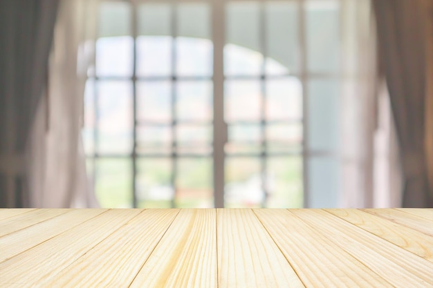 Empty wood table top with window curtain abstract blur background for product display