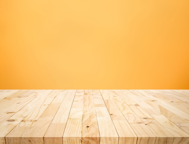 Empty of wood table top on yellow pastel color background