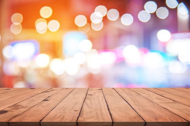 Empty wood table with colorful abstract bokeh