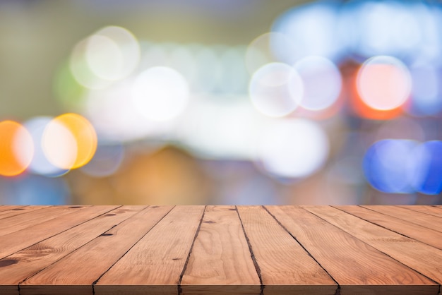 Empty wood table with colorful abstract bokeh