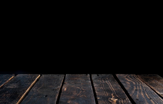 Empty wood tabletop on dark moody background Premium Photo