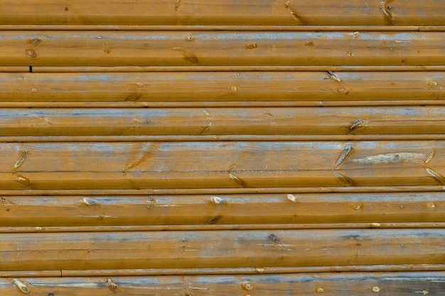 The empty wooden background is dark orange The boards are positioned horizontally Knots on the wood surface