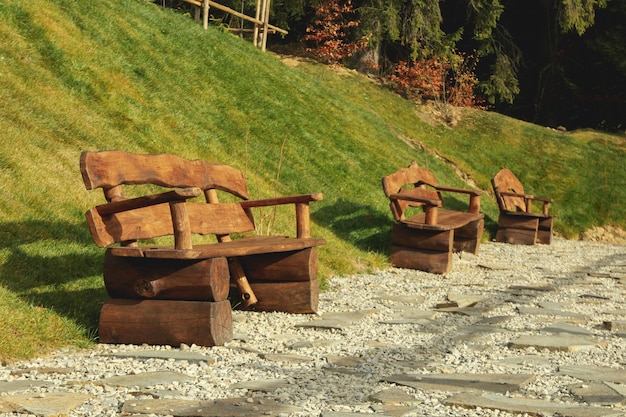 Empty wooden benches outdoor in sunny day