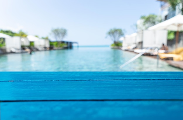 Empty wooden board on blur the pool at the sea