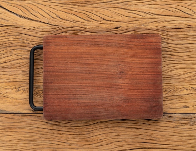 Empty wooden board over wooden table with copy space