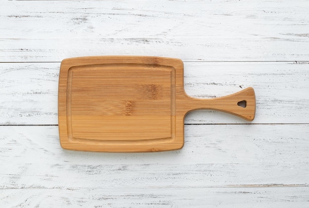 Empty wooden board over wooden table with copy space