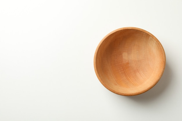 Empty wooden bowl on white