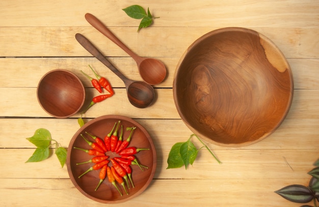 An empty wooden bowl on wooden background