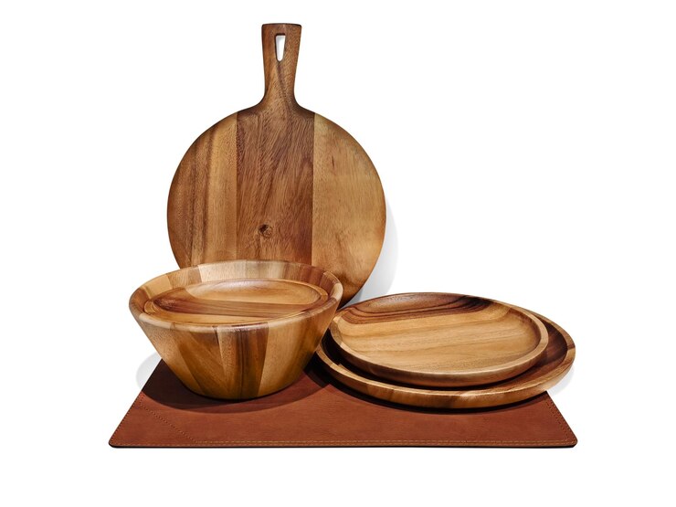 फोटो empty wooden bowl wooden pizza board on a separate sheet of leather on a white background