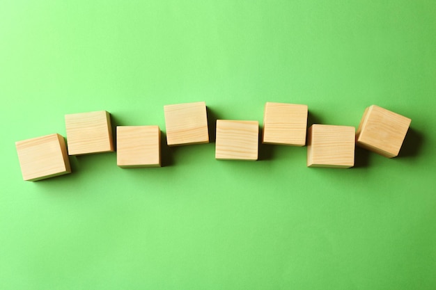 Empty wooden cubes on color background