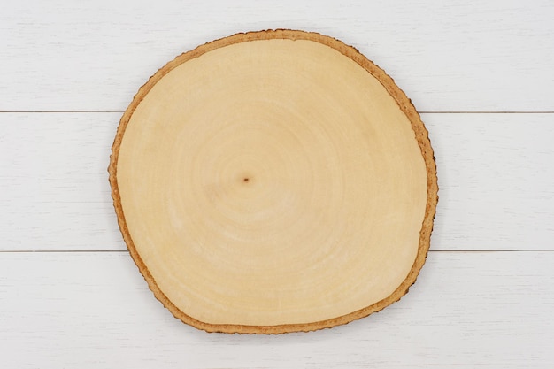 Empty wooden cutting board on white wooden table Top view image