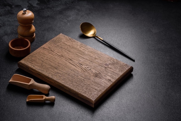 An empty wooden cutting board with wooden cutlery