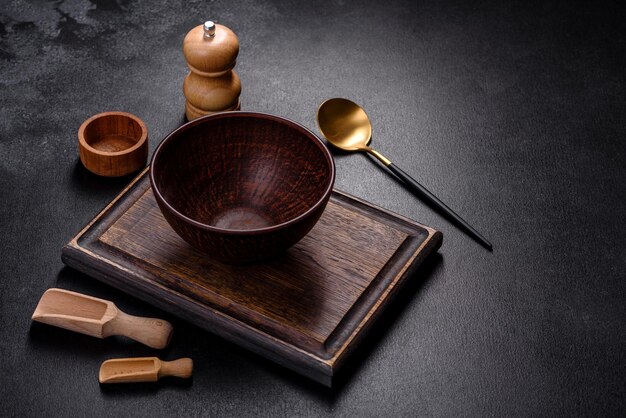 An empty wooden cutting board with wooden cutlery