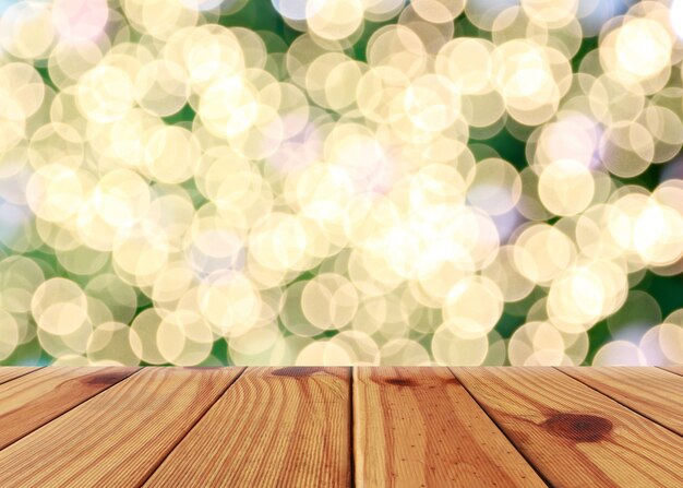 板のテーブルの空の木の床とクリスマスの背景のボケの光。
