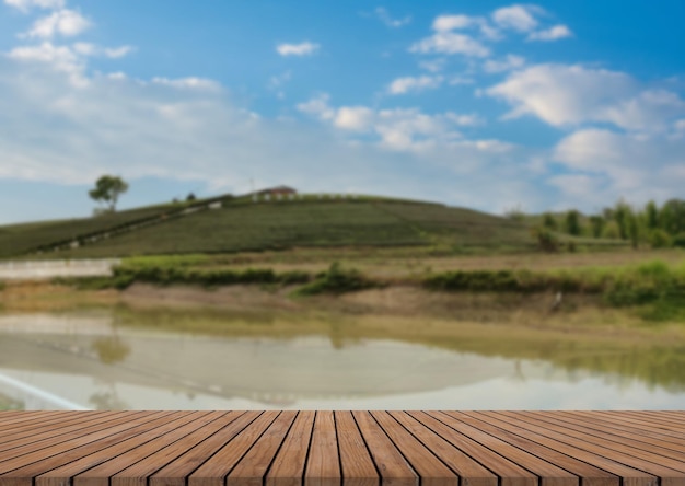 Empty wooden floor with blurred tea plantations Can be used for product display editingxA