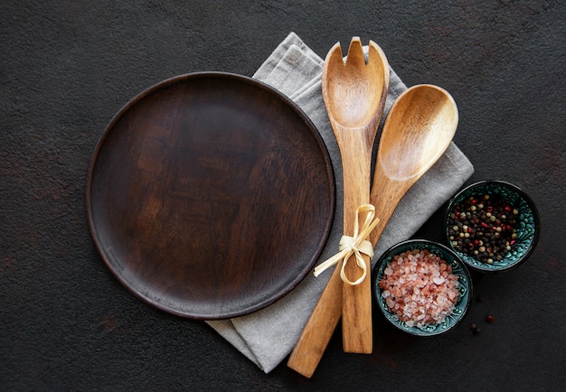 Empty wooden plate on a black background