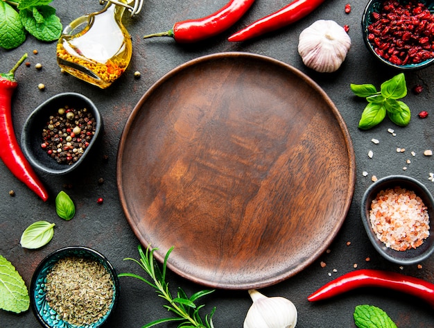 Empty wooden plate and frame of spices