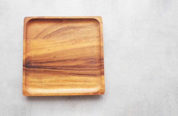 Empty wooden plate on gray cement table background