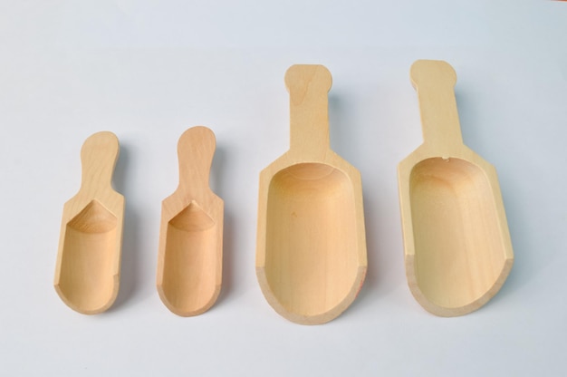 Empty wooden scoops isolated on a white background