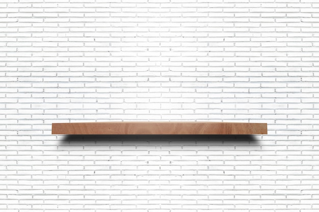 Empty wooden shelf on old white brick wall texture. For display products.