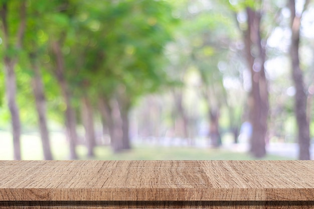 Empty wooden table over blurred park nature background