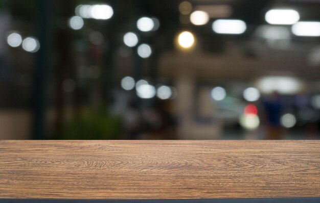 Empty wooden table in front of abstract blurred background of coffee shop can be used for display or montage your productsMock up for display of product