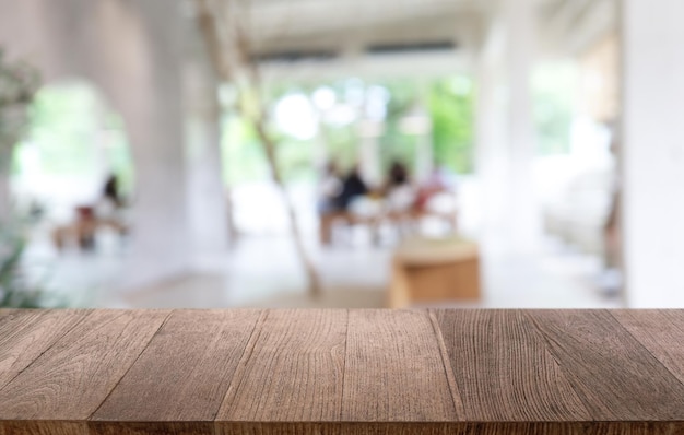 Empty wooden table in front of abstract blurred background of coffee shop can be used for display or montage your productsMock up for display of product