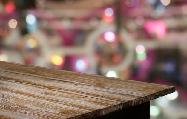 Empty wooden table in front of abstract blurred background of coffee shop can be used for display or montage your productsMock up for display of product