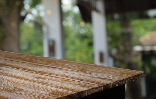 Empty wooden table in front of abstract blurred background of coffee shop wood table in front can be used for display or montage your productsMock up for display of product