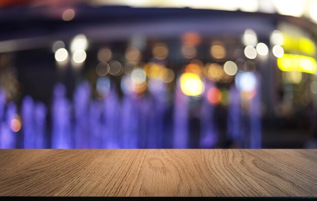 Empty wooden table in front of abstract blurred background of coffee shop wood table