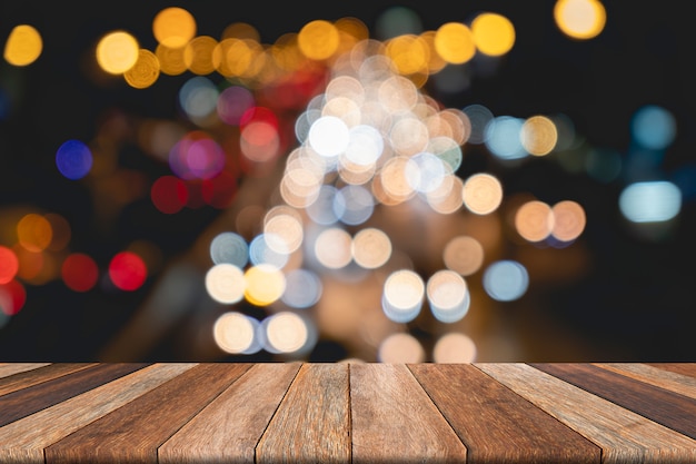 Empty wooden table on front blurred traffic bokeh background