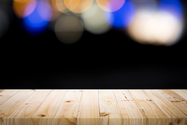 Empty wooden table platform on bokeh at nigh.