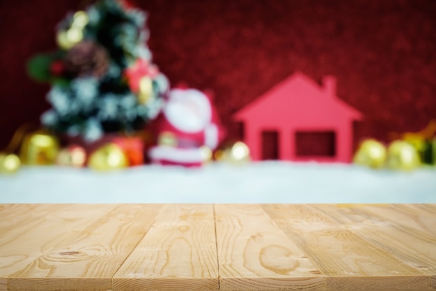 Empty wooden table platform with over blurred blue christmas decorations background for presentation product.