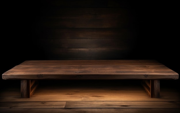 An empty wooden table for presentation with a dark background and isolated recessed lighting