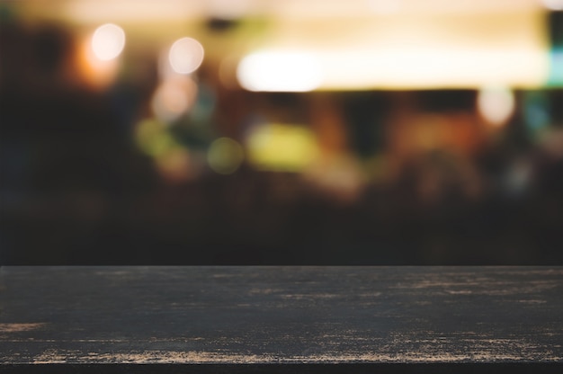 empty wooden table with blurred cafe, product montage display background.