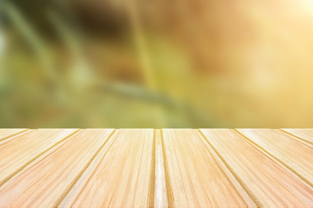 Empty wooden table with blurred green background. concept party, products, spring