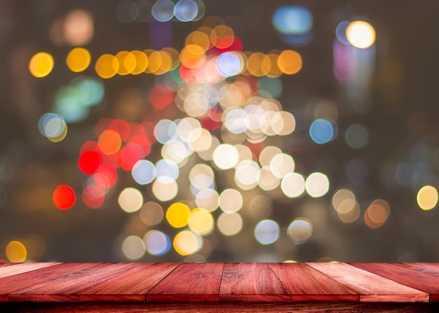 Empty wooden table with blurred lights abstract color background. For display or montage your products.